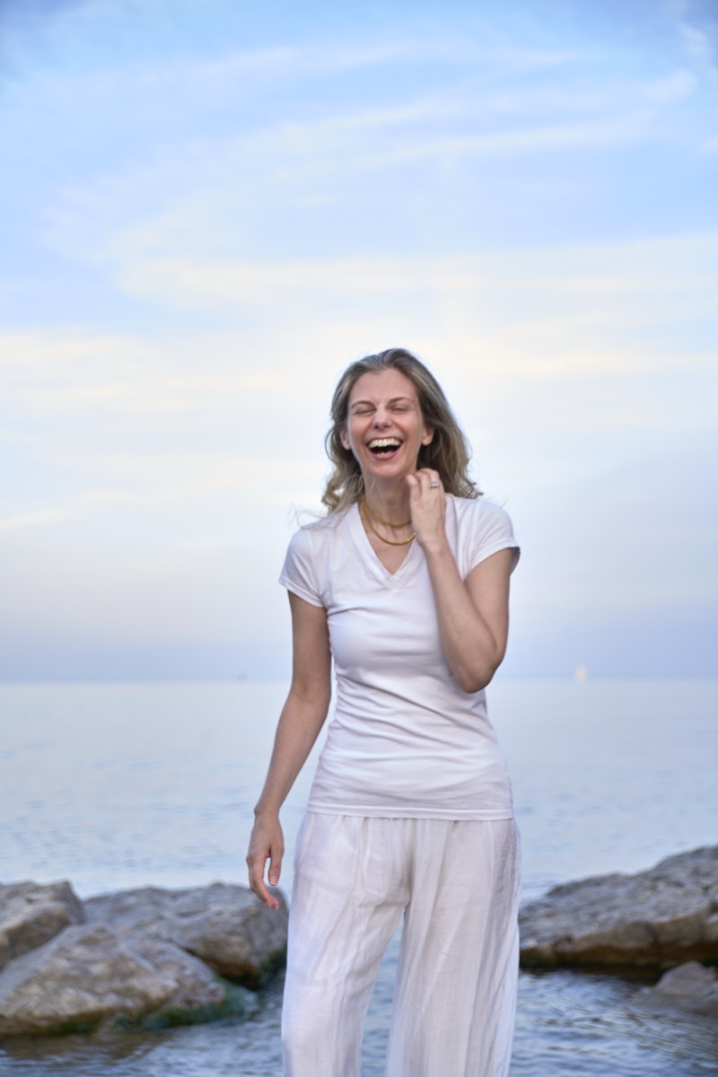 Julia Arbuckle laughing beside Lake Ontario.