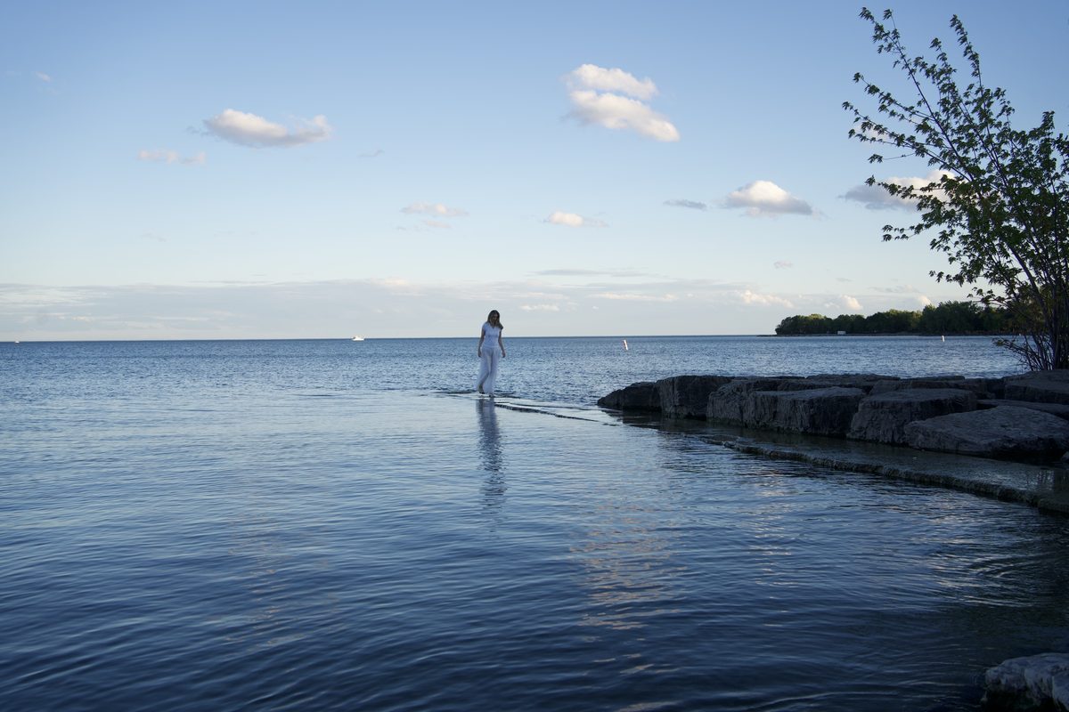 Julia Arbuckle seated quietly by the water.